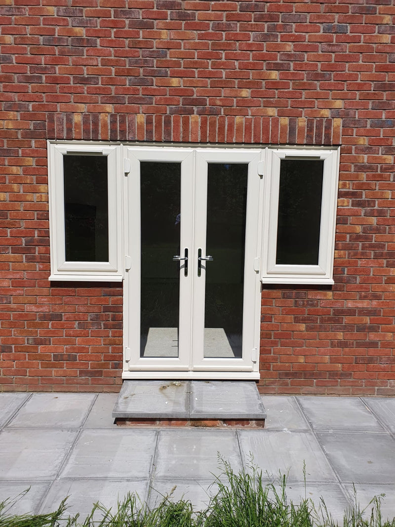 White double doors with windows on a brick wall