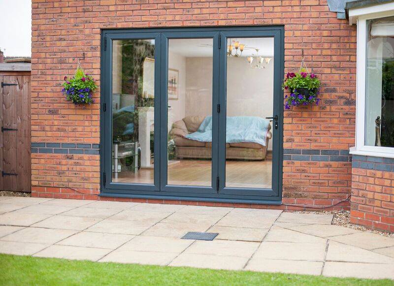 Blue sliding glass door on a brick wall with garden view